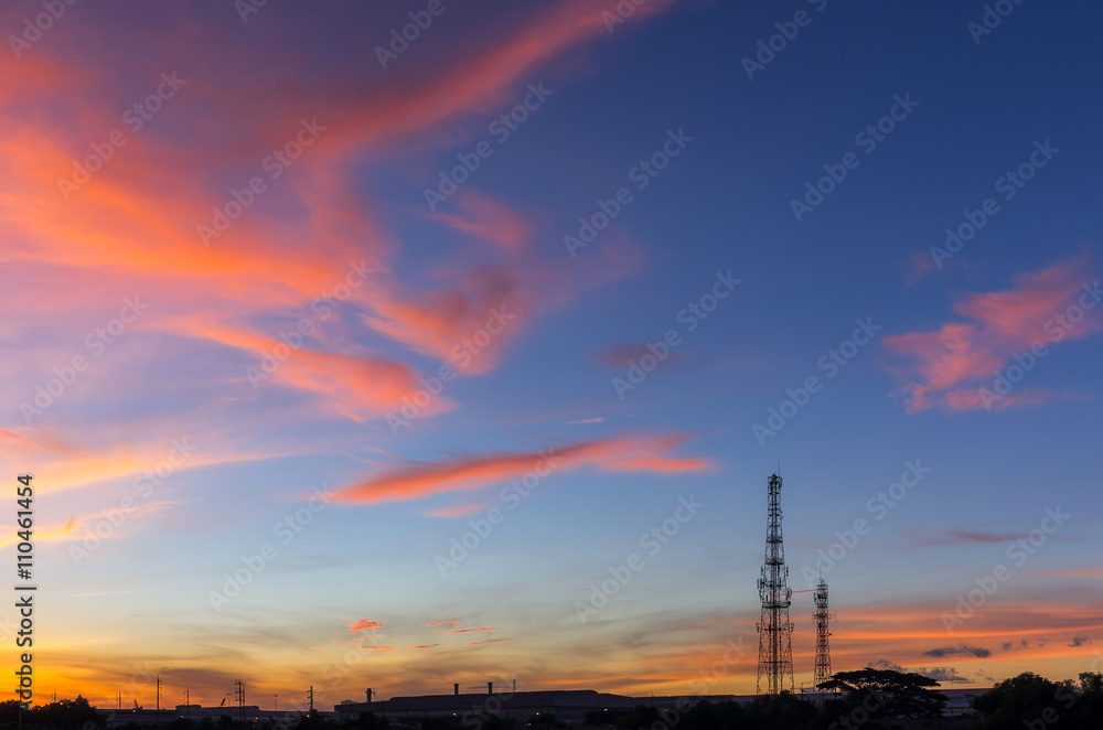 Sky with silhouettes of radio antenna.