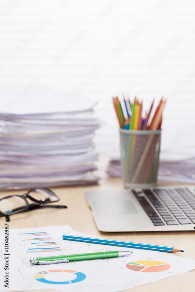 Office workplace with laptop, reports and pencils Office workplace with laptop, reports and pencils
