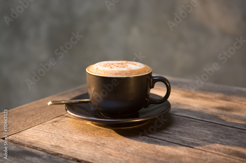 Hot cappuccino coffee cup on wooden table