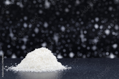 Coconut desiccated on black stone table