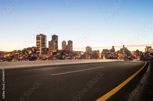 empty asphalt road with cityscape and skyline of san francisco