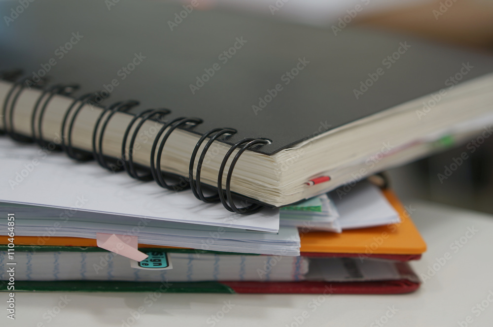 Black notebook and report document Black notebook and report document
