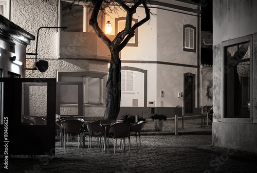 Street cafe in old european town at night