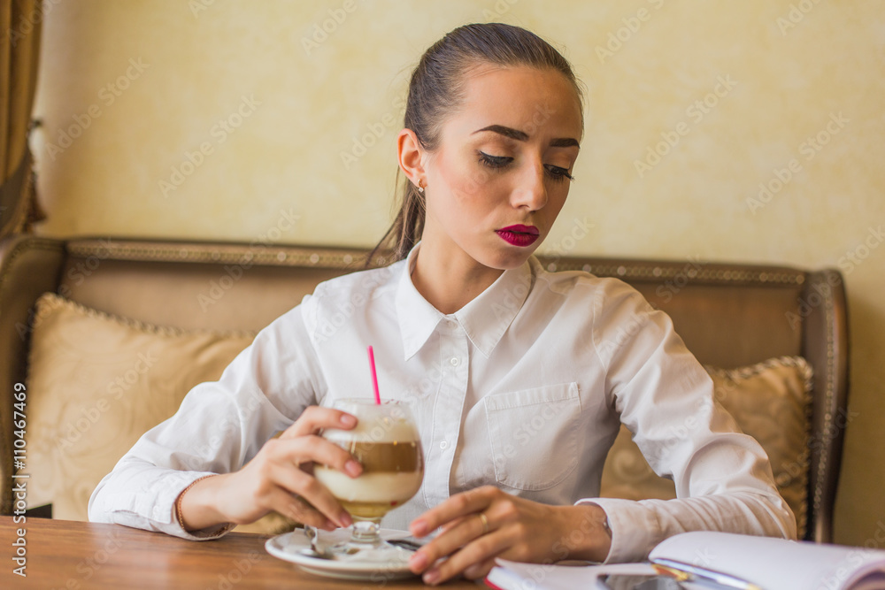 Business woman drinking latte coffee in restaurant. Business woman drinking latte coffee in restaurant.