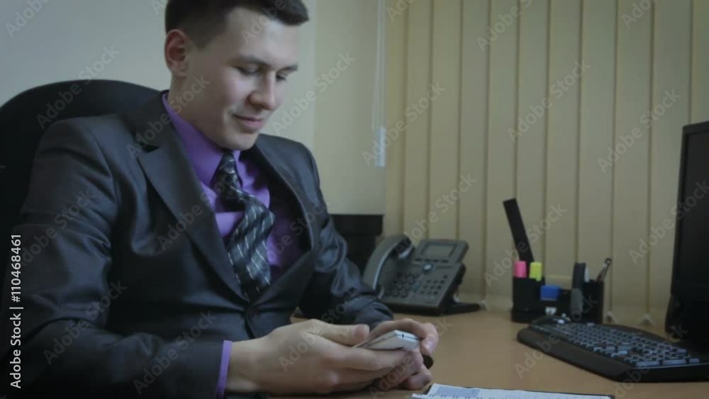 Businessman working in office. He decides to call his girlfriend. Businessman working in office. He decides to call his girlfriend.