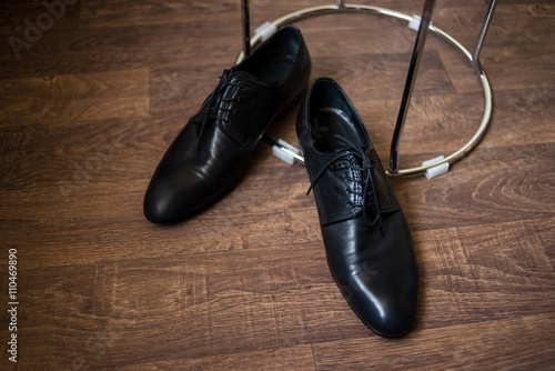 black male shoes on the wooden surface top view