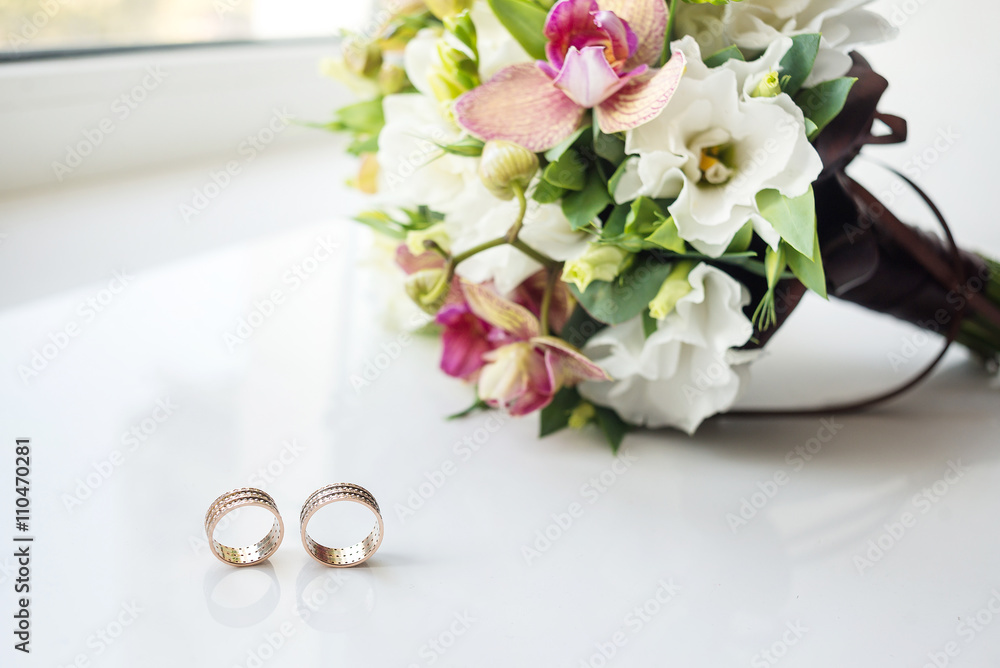 bridal bouquet on white background and two gold rings. Wedding card bridal bouquet on white background and two gold rings. Wedding card