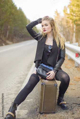 Beautiful young girl hitchhiking in the United States and Canada.