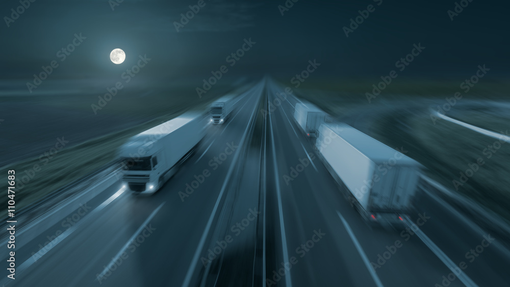 Motion image of modern delivery trucks on the highway at night