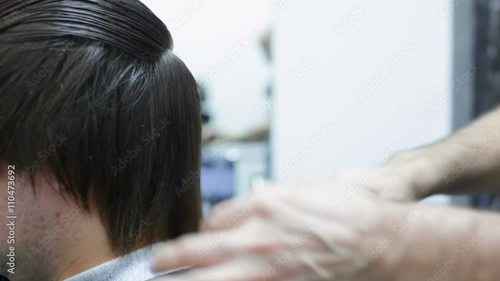Cuffieur cut wet male hair. Cutting wet hair with scissors.