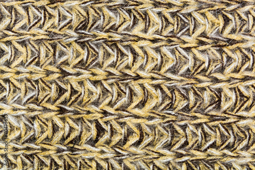 mottled horizontal texture of the wool yellow brown knitted fabric