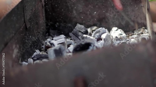 Close view at a glowing charcoal and flame in the barbecue grill photo