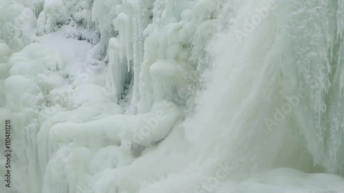 Slow motion of a frozen waterfall named Ristafallet in Jamtland in northern Sweden photo