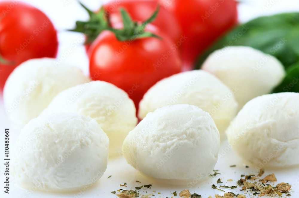 mozzarella cheese balls, ripe cherry tomatoes, greens and spices mozzarella cheese balls, ripe cherry tomatoes, greens and spices