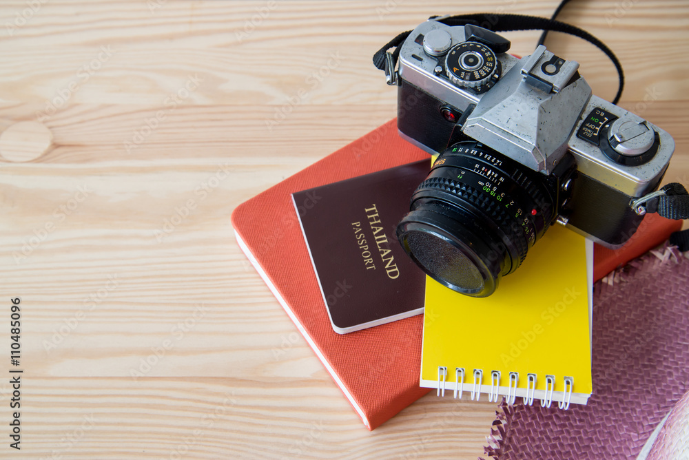 Travel background with notebook, old camera and passport
