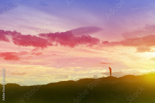 Boy standing grudge on sunset view, silhouette concept