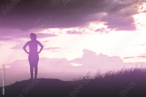 woman standing alone at the field during beautiful sunset © Johnstocker