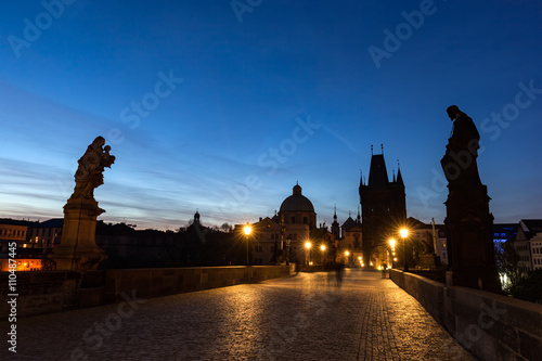 Charles Bridge at sunrise, Prague, Czech Republic. Dramatic statues and medieval towers.
