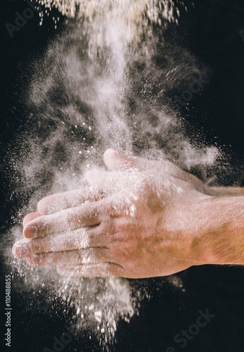 adult man hands work with flour  dark photo