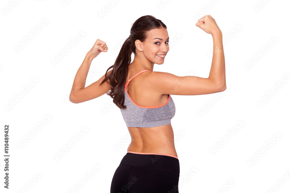 In love with sport. A young beautiful woman in gym clothes flexing her arms against white isolated background. In love with sport. A young beautiful woman in gym clothes flexing her arms against white isolated background.
