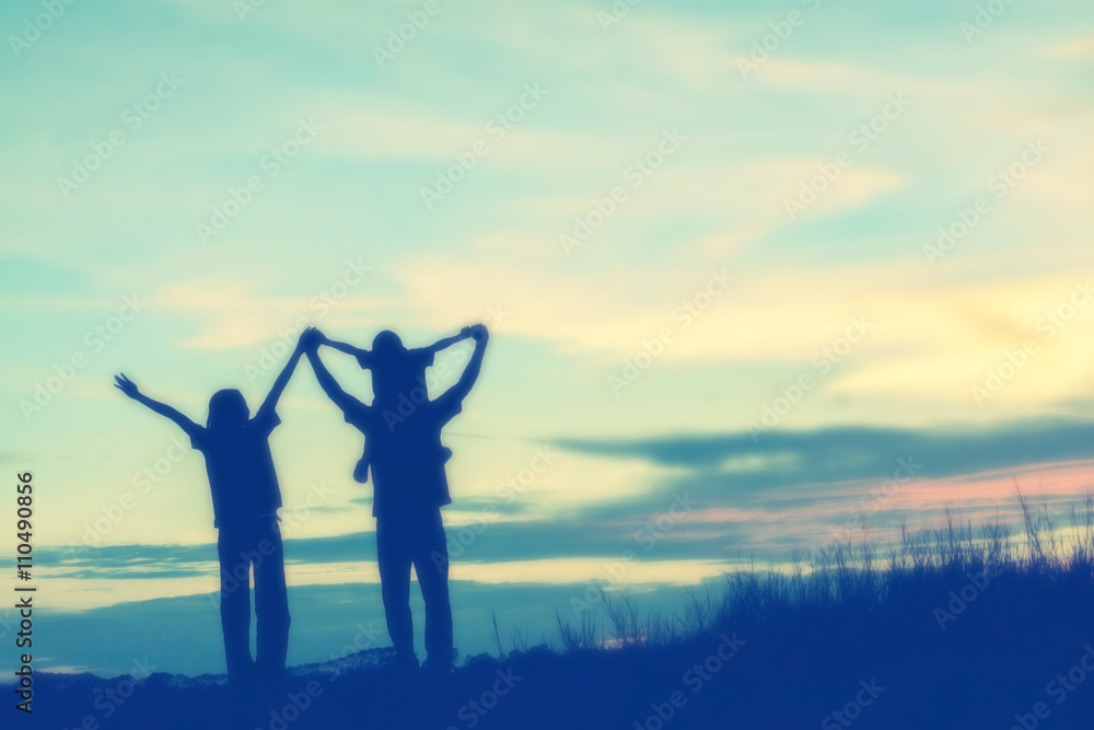 Fototapeta premium silhouette of a happy family and happy time sunset