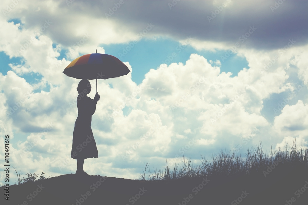 silhouette of woman holding umbrella sunny day