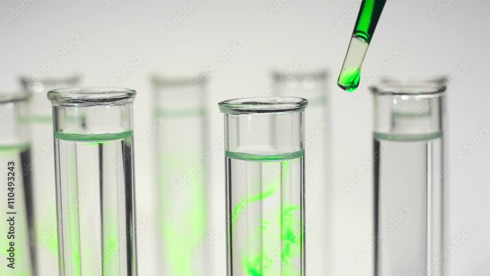 Biological experiment. Drop green liquid in test tubes with water. Biological experiment. Drop green liquid in test tubes with water.