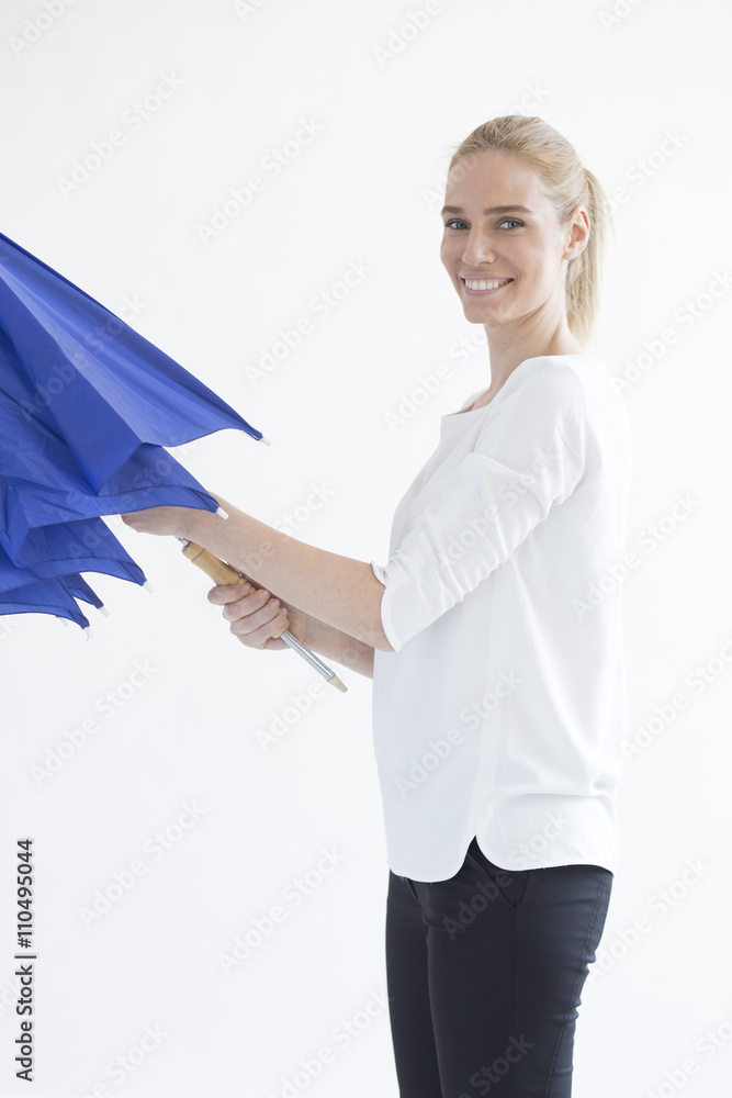 Beautiful blonde woman opening closing umbrella isolated on white background Beautiful blonde woman opening closing umbrella isolated on white background