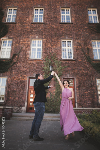 Young wedding couple in love story, bride and groom posing near building on the background. Krakow © olegparylyak