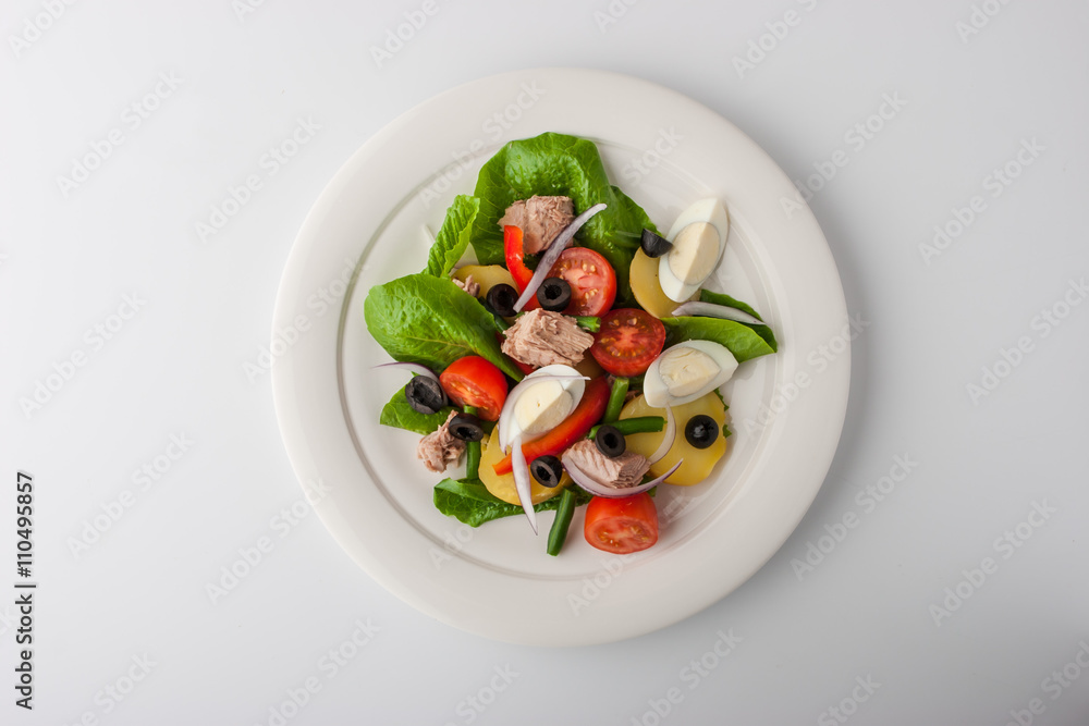 Nicoise salad with tuna on white ceramic plate