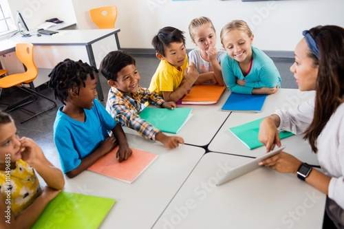 Aerial view of pupils and teacher with tablet