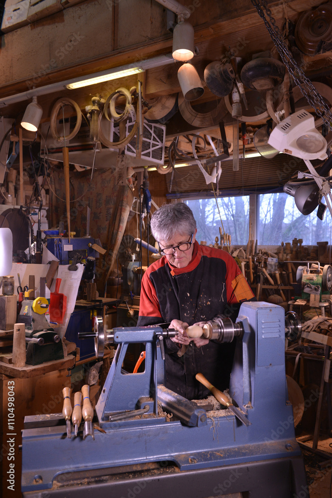 Woodturners using a rotating clamp to turn the wood.