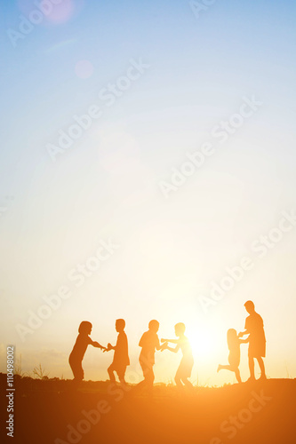 Children playing on summer sunset happy time