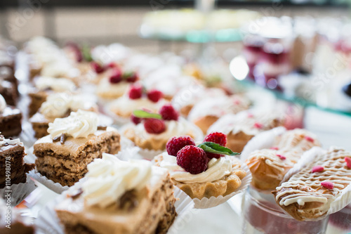 Luxury cakes on wedding dessert table in restaurant