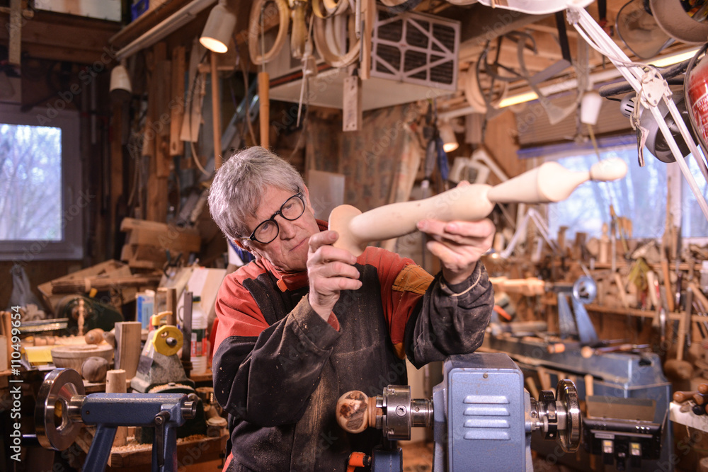 Woodturners using a rotating clamp to turn the wood.