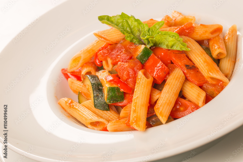 close up of pasta with tomatoes, zucchini and basil close up of pasta with tomatoes, zucchini and basil