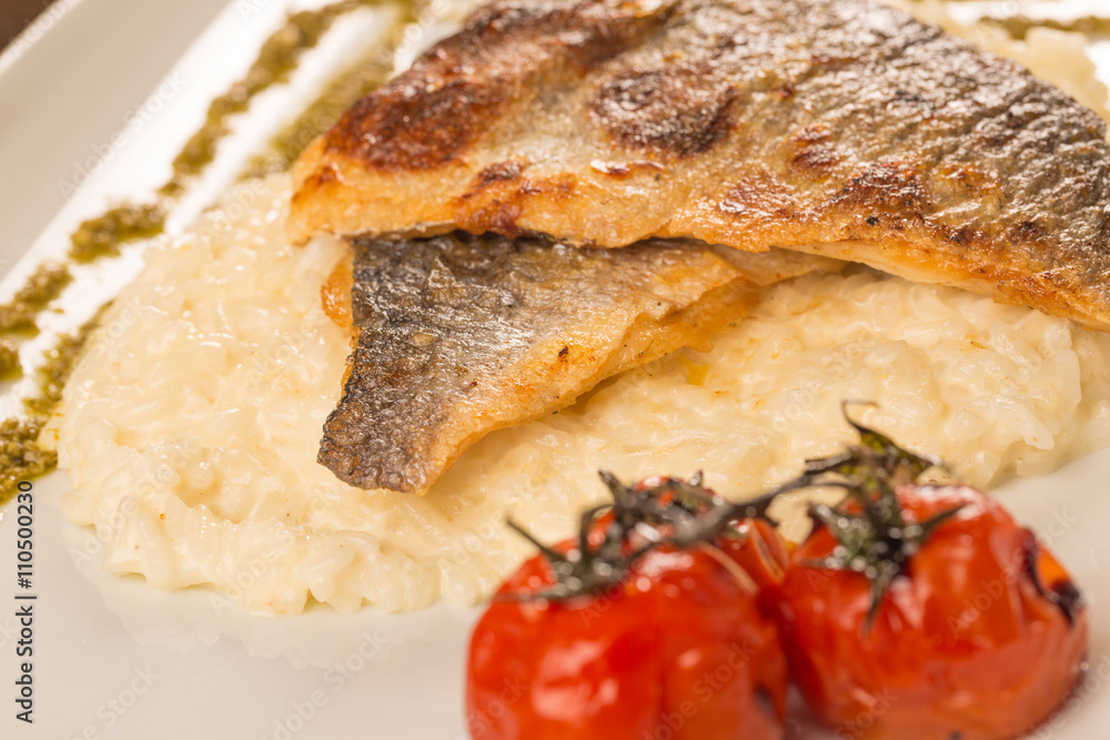 Grilled trout with risotto, tomatoes, and pesto Grilled trout with risotto, tomatoes, and pesto