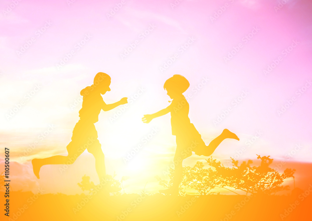 little boy with little girl jumping to sky and having happy time little boy with little girl jumping to sky and having happy time