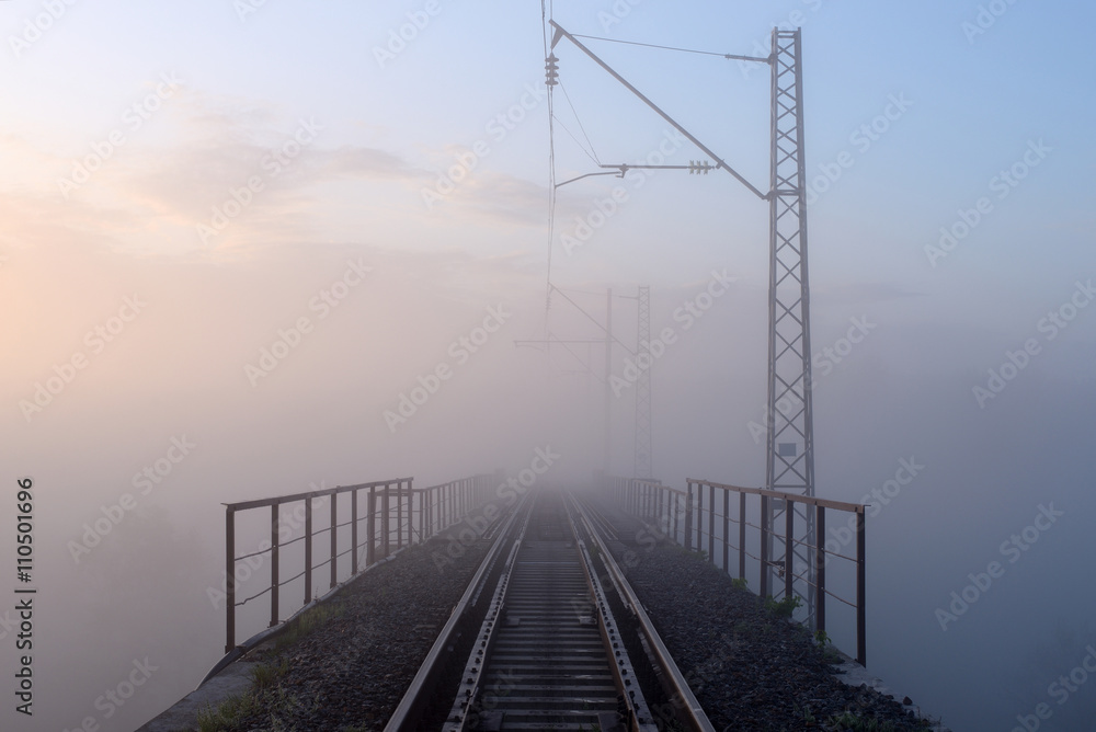Sunrise and morning mist over the railway