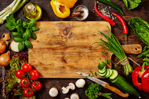 Cutting Board and Knife with Vegetables on Table photo
