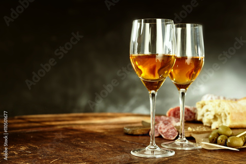 Two glasses of sherry with tasty tapas