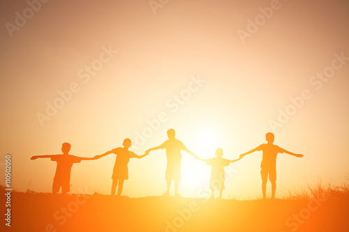 Silhouette Children playing on summer sunset happy time