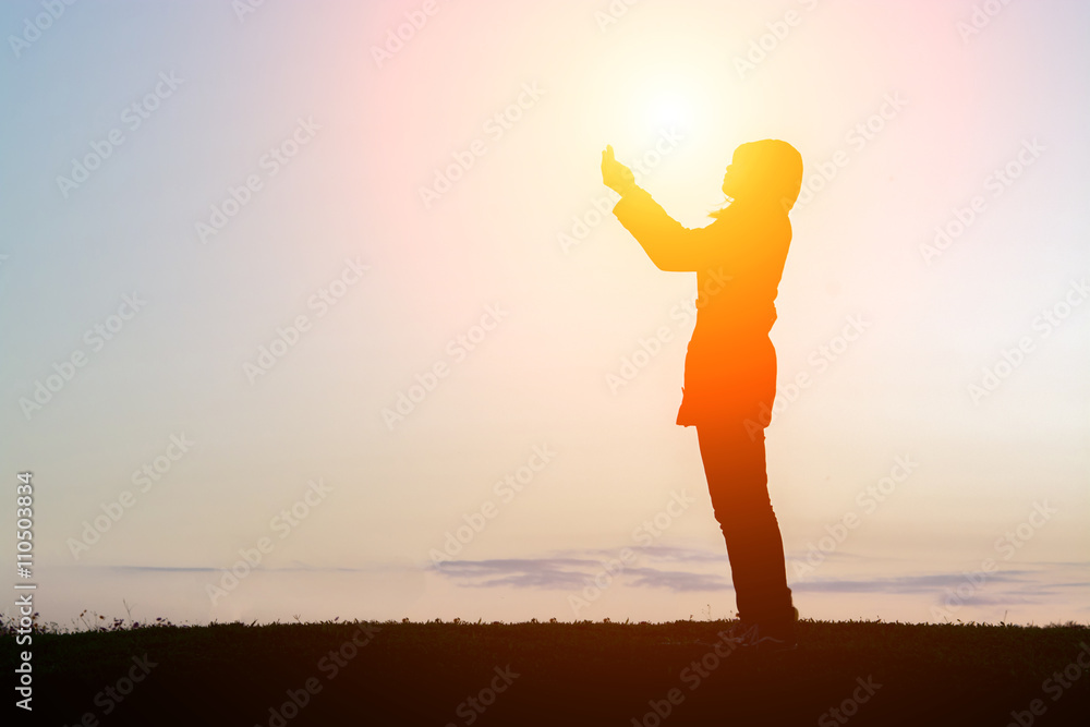 silhouette of woman stand praying