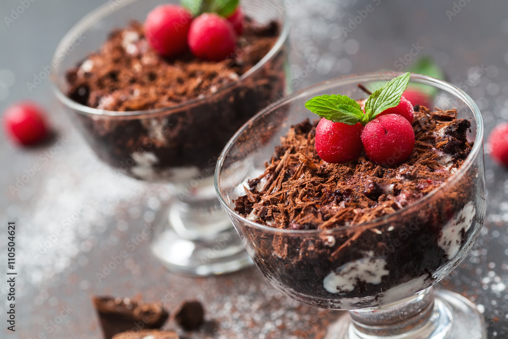 Chocolate desserts with whipped cream and cherries in glasses, selective focus, close up Chocolate desserts with whipped cream and cherries in glasses, selective focus, close up