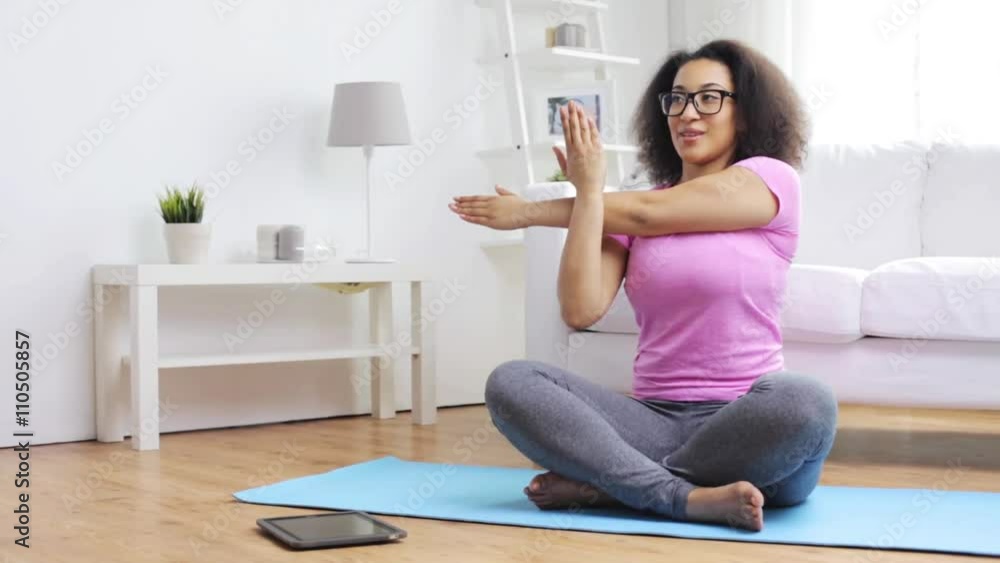 happy african woman exercising on mat at home happy african woman exercising on mat at home