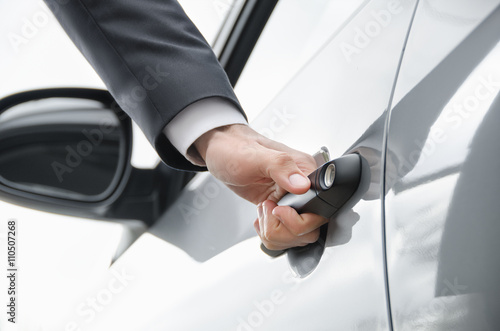  Close-up of businessman  opening a car door.