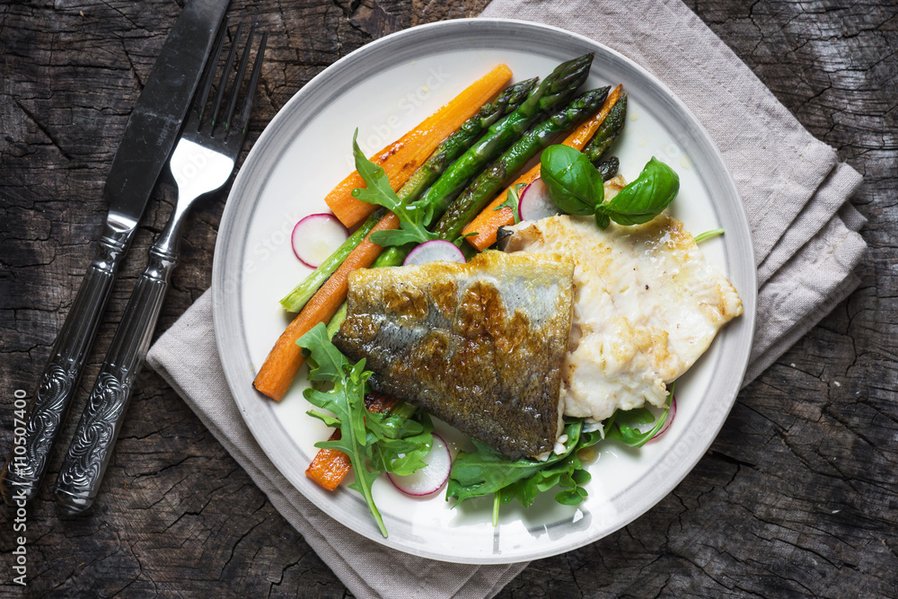 Fish fillet with vegetables on wooden background Fish fillet with vegetables on wooden background