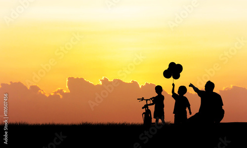 Silhouette of father and boy standing  sunset background © napatcha
