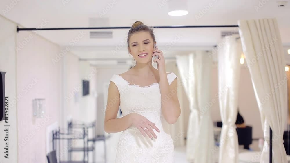 joyful bride talking on the phone and smile joyful bride talking on the phone and smile