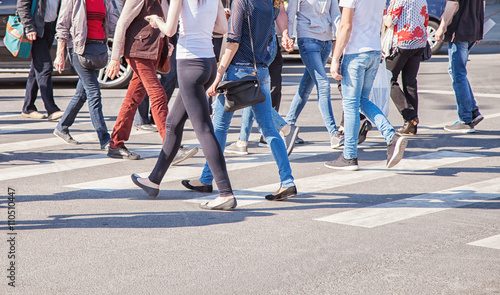 Fotografiet pedestrians walking on a crosswalk